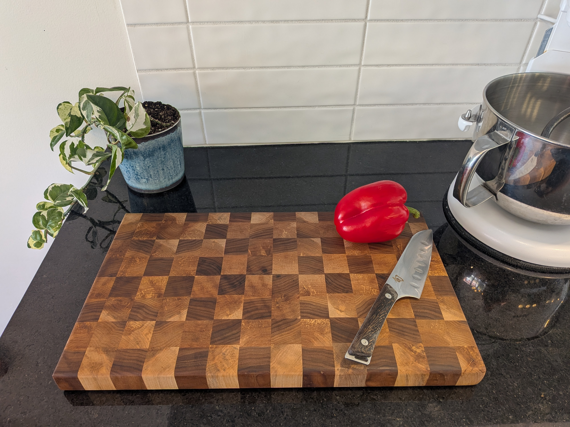Planche à découper en bois de bout, motif damier avec poivron rouge